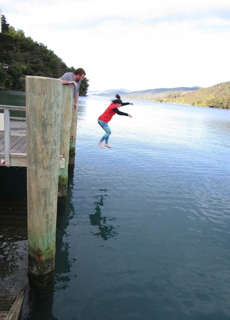 Linda reliving memories of Outward Bound by jumping off the wharf